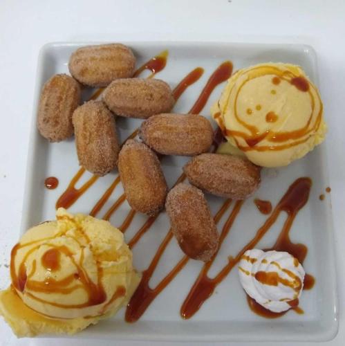 a white plate topped with different types of pastries at Prestige Motel in Curitiba
