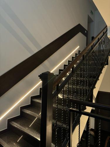 a staircase with black railings in a house at Hotel zum Rittersprung in Altenahr