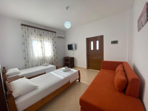 a living room with two beds and a couch at Ergys Apartments in Ksamil