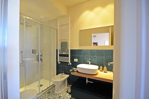 a bathroom with a sink and a shower and a toilet at Maremma 1851 in Follonica