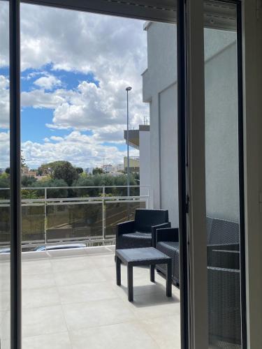 a balcony with a chair and a window with a view at Estelle in Bari