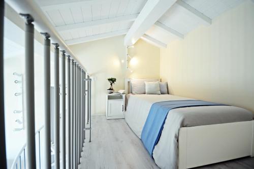 a bedroom with a bed in a white room at Maremma 1851 in Follonica