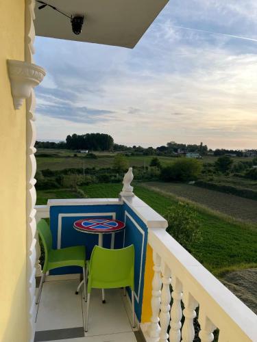 a porch with a table and chairs on a balcony at HILL Of SAN PIETRO in Durrës