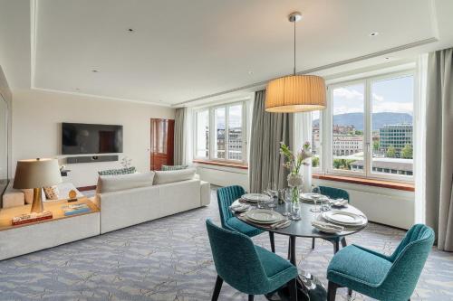 a living room with a couch and a table and chairs at Mandarin Oriental, Geneva in Geneva