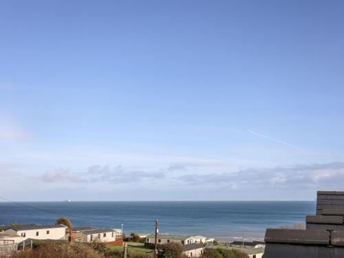 a view of the ocean from a building at Sandy Bay Retreat in Benllech