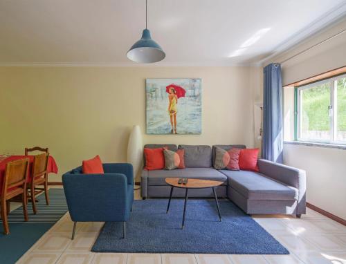 a living room with a couch and a table at Apartamento T3 em Pombal in Pombal