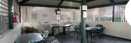 a restaurant with tables and chairs and a counter at North Arm Tourist Park in Lakes Entrance