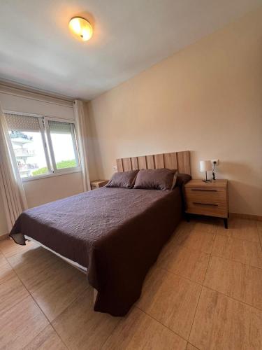 a bedroom with a large bed and a window at APCOSTAS Villa de Madrid in Blanes