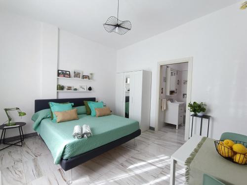a bedroom with a green bed with shoes on it at Oleum in Mesagne