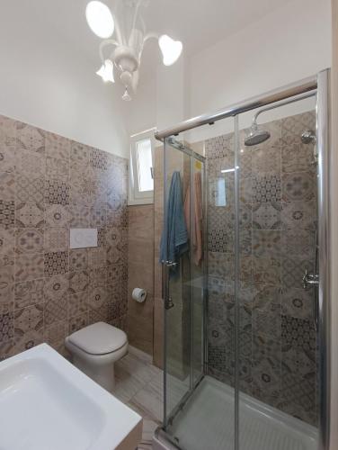a bathroom with a shower and a toilet at Oleum in Mesagne