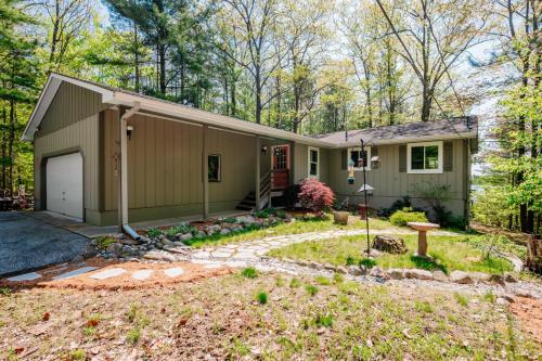 a house in the woods with a yard at Lake Front-fishing-all sports Bass Lake Sanctuary in Traverse City