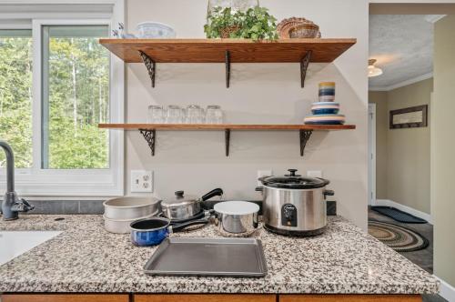 a kitchen counter with pots and pans on it at Lake Front-fishing-all sports Bass Lake Sanctuary in Traverse City
