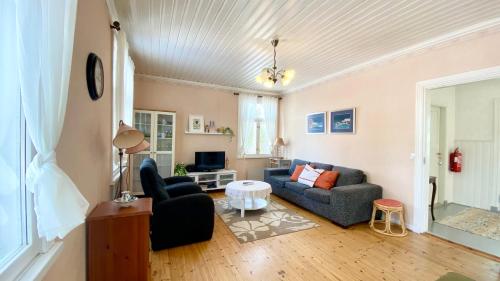 a living room with a couch and a table at Wästinn in Vöyri