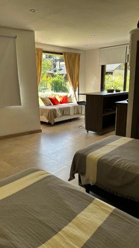 a hotel room with two beds and a piano at Chacras House in Chacras de Coria