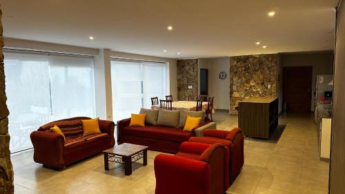 a living room with two couches and a table at Chacras House in Chacras de Coria