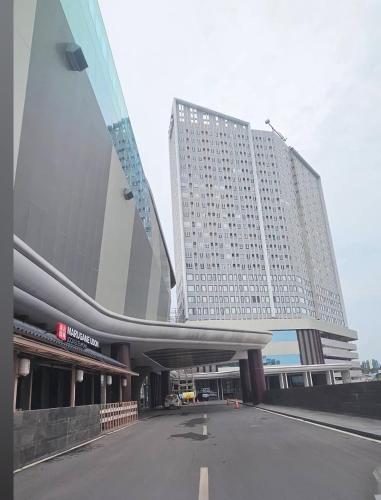 a large building with a parking lot in front of it at Apartment The Bay AisBeLL in Kuala