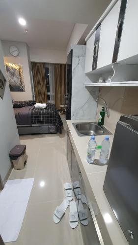 a kitchen with remotes on the counter and a sink at Apartment The Bay AisBeLL in Kuala