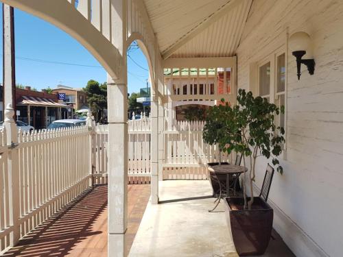 a porch with a table and a potted plant at The Heritage - located in in the center of Glenelg in Glenelg