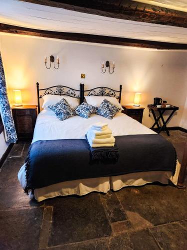 a bedroom with a large bed with two pillows at The New Inn in Yeovil