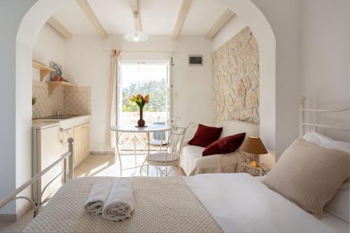 a bedroom with a bed and a table in a room at Poolside Stone Residences - Marina Bok in Novalja