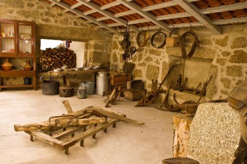 a room filled with wooden furniture in a stone building at Solar dos Caldeira e Bourbon in Zebras
