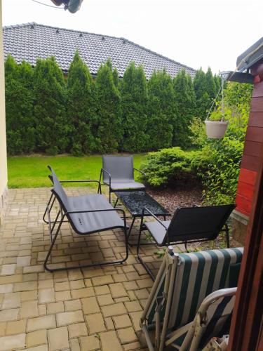 a group of chairs and tables on a patio at Vila Callum RELAX & WELLNESS in Ostrava
