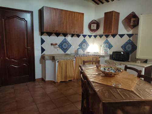 a kitchen with a table with a bowl on it at Le Case di Zia Palma in Custonaci
