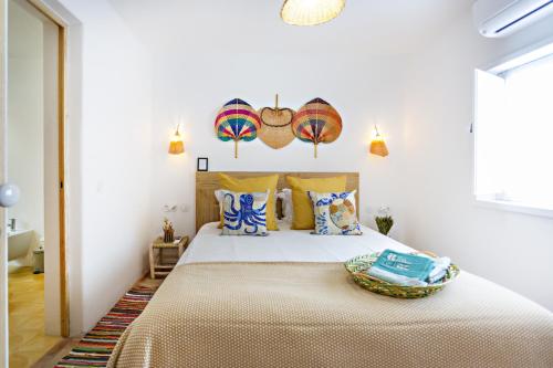 a bedroom with a large bed with yellow pillows at Casa dos Avos in Santa Luzia