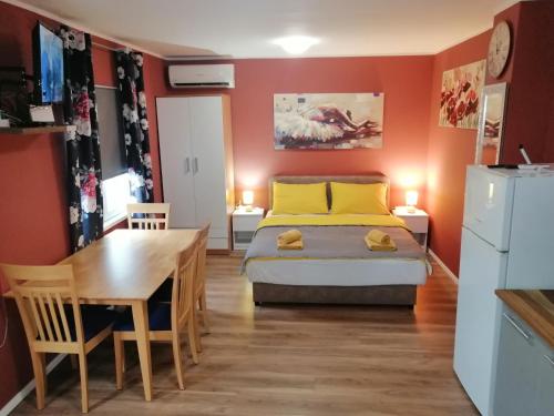 a bedroom with a bed and a table and a desk at City Break Apartment in Zagreb