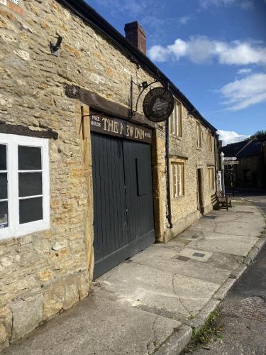an old brick building with a door on it at The New Inn in Yeovil
