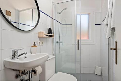 a bathroom with a sink toilet and a mirror at Mon Palau in Sant Lluis