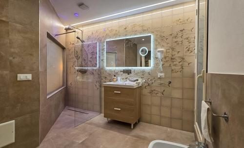 a bathroom with a sink and a mirror at Airam in Cefalù