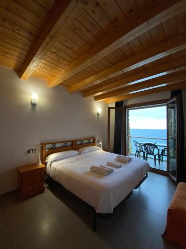 a bedroom with a bed with a view of the ocean at Agroturismo Itxaspe in Orio