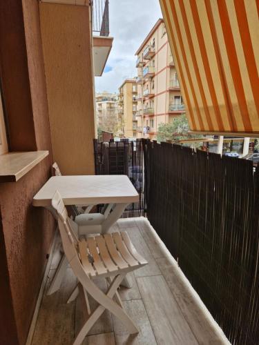 a table and a chair on a balcony at Il Mare di Roma Deluxe in Lido di Ostia
