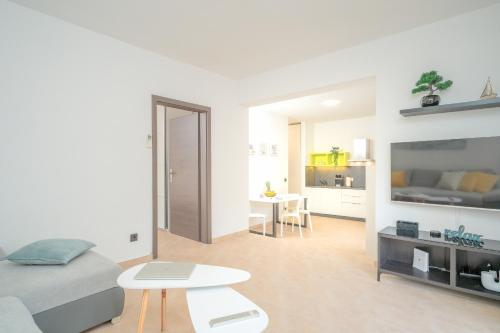a white living room with a bed and a table at Apartment Marin - ZF Hvar in Vrboska