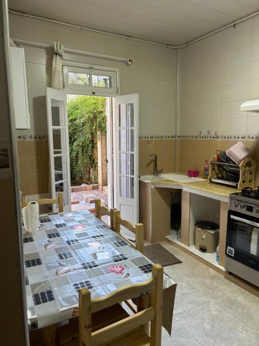 a kitchen with a table in the middle of it at Yassine's home in Jijel
