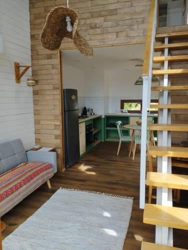 a living room with a staircase and a kitchen at Casa del mar Chiloé in Chonchi