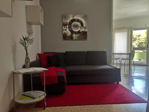 a living room with a couch and a red rug at La Castillo in Santa Cruz de Tenerife