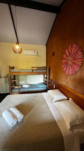 a bedroom with a large bed with two pillows on it at Espaco Morro do Frota in Pirenópolis