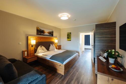 a hotel room with a bed and a couch at Familienhotel Trebesingerhof in Trebesing