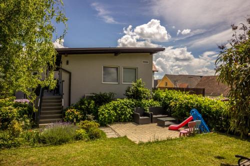 a backyard with a house and a playground at Apartment Šelih in Maribor