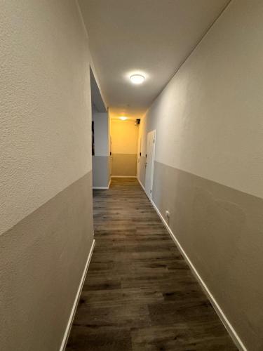 an empty hallway with a long corridor with white walls at F-F Haus Monteuren Unterkunft in Neuhausen auf den Fildern