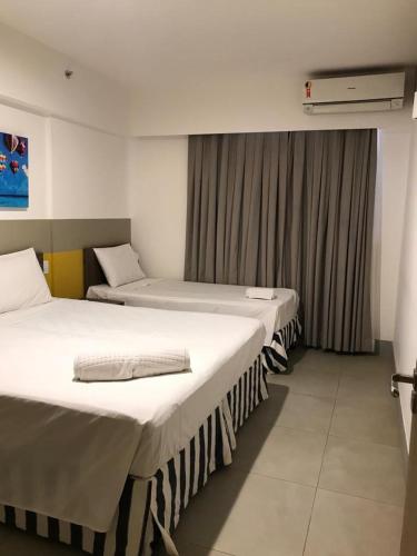 zwei Betten in einem Zimmer mit Fenster in der Unterkunft Olímpia Park Resort in Olímpia