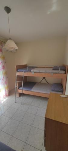 a bedroom with a bunk bed in a room at Stella apartments in Olympiaki Akti