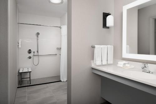 a white bathroom with a shower and a sink at Homewood Suites by Hilton San Antonio Riverwalk/Downtown in San Antonio