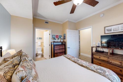 a bedroom with a bed and a ceiling fan at Waters Edge Condominiums in Fort Walton Beach