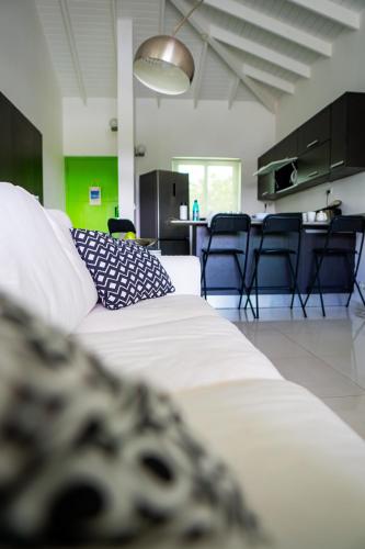 a living room with a white couch and some chairs at Piscadera Harbour Village in Willemstad
