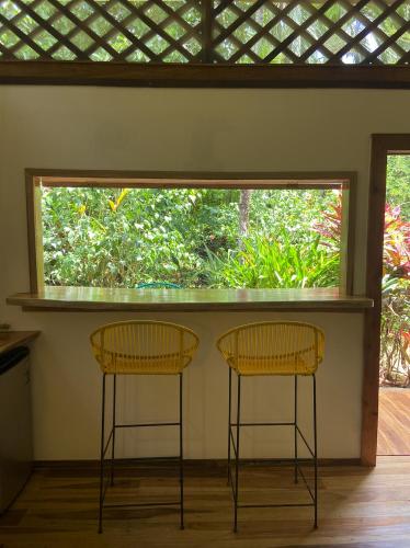 two chairs sitting in a room with a window at Passion Fruit Lodge in Cahuita