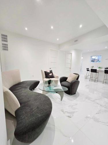 a living room with couches and a table and chairs at Comfortable Room in Toronto next to Yorkdale mall in Toronto