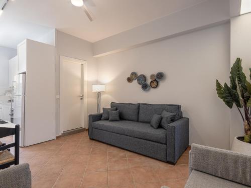 a living room with a couch and a table at Elena Seafront Luxury Apartments in Almirida